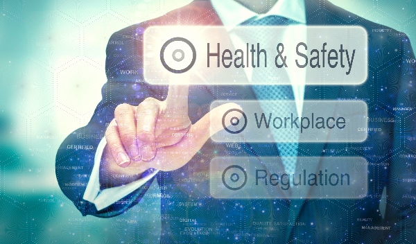 A business person wearing a suit taps a button labeled health and safety, right over one labeled workplace.