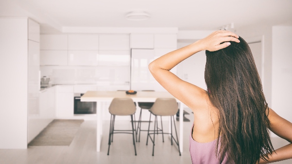 A homeowner stands in front of her bare kitchen, unsure where to begin her spring remodeling project.